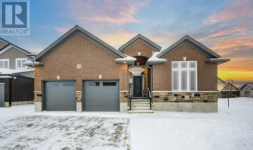 View of property featuring a garage - 705 Hollinger Drive S, Listowel, ON - Outdoor With Facade