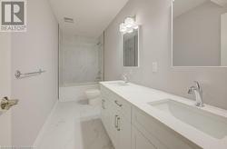 Full bathroom featuring tiled shower / bath combo, toilet, and vanity - 