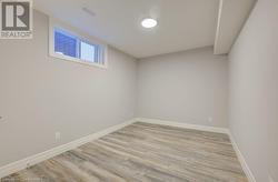 Basement featuring light wood-type flooring - 