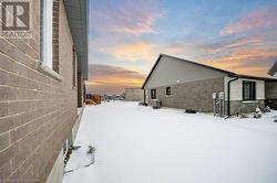 View of snow covered exterior with cooling unit - 