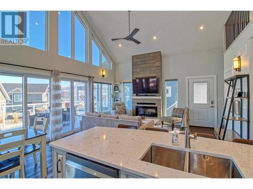 6742 Marbella Loop Unit# 302, Kelowna, BC - Indoor Photo Showing Kitchen With Fireplace With Double Sink