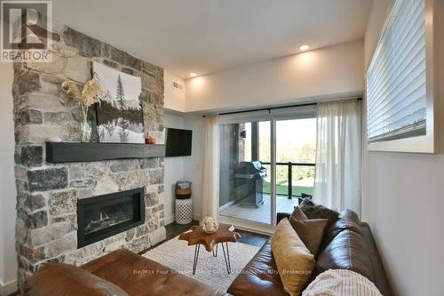 207 - 12 Beausoleil Lane, Blue Mountains (Blue Mountain Resort Area), ON - Indoor Photo Showing Living Room With Fireplace