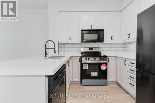 2010 - 70 Absolute Avenue, Mississauga, ON - Indoor Photo Showing Kitchen With Double Sink