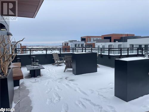 Snow covered patio with exterior bar and a fire pit - 490 Gordon Krantz Avenue Unit# 602, Milton, ON - Outdoor