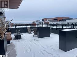 Snow covered patio with exterior bar and a fire pit - 