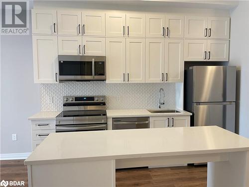 Kitchen with white cabinets, stainless steel appliances, and sink - 490 Gordon Krantz Avenue Unit# 602, Milton, ON - Indoor Photo Showing Kitchen With Stainless Steel Kitchen With Upgraded Kitchen