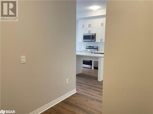 Corridor featuring wood-type flooring - 490 Gordon Krantz Avenue Unit# 602, Milton, ON - Indoor Photo Showing Other Room