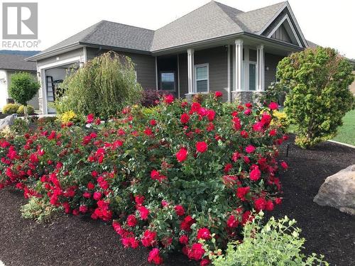 Seasonal Summer Perennial Flowers on the front yard  property - 3400 Kingfisher Road, West Kelowna, BC - Outdoor With Deck Patio Veranda