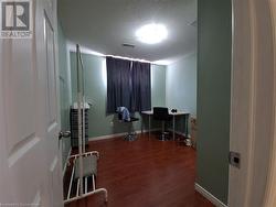 Home office with hardwood / wood-style floors and a textured ceiling - 