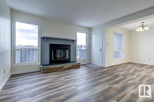 #14 4610 17 Av Nw, Edmonton, AB - Indoor Photo Showing Living Room With Fireplace