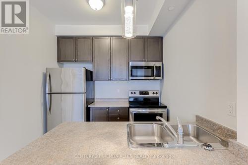 211 - 84 Aspen Springs Drive, Clarington, ON - Indoor Photo Showing Kitchen With Stainless Steel Kitchen