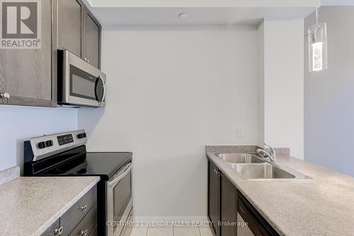 211 - 84 Aspen Springs Drive, Clarington, ON - Indoor Photo Showing Kitchen With Double Sink