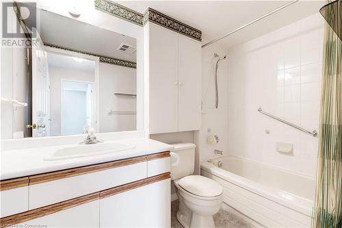 Full bathroom featuring tiled shower / bath combo, toilet, and vanity - 870 Upper Wentworth Street Unit# 202, Hamilton, ON - Indoor Photo Showing Bathroom