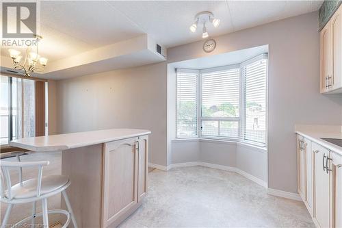 Kitchen with a chandelier, pendant lighting, and a textured ceiling - 870 Upper Wentworth Street Unit# 202, Hamilton, ON - Indoor Photo Showing Kitchen