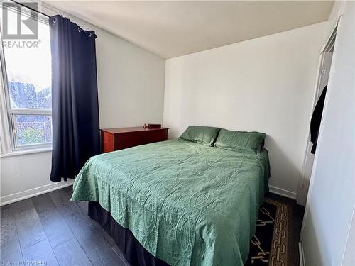 Bedroom featuring dark wood-type flooring - 21 Minto Avenue, Hamilton, ON - Indoor Photo Showing Bedroom