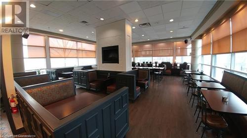 Kitchen featuring plenty of natural light, dark hardwood / wood-style floors, and blue cabinetry - 198 King Street W, Kitchener, ON 