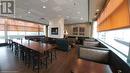 Dining area featuring a paneled ceiling, dark hardwood / wood-style floors, a wall of windows, and a wealth of natural light - 198 King Street W, Kitchener, ON 