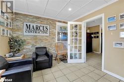 Living area featuring tile patterned flooring and ornamental molding - 