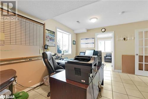 Tiled office space with a textured ceiling and french doors - 8876 County Road 56, Utopia, ON 