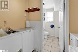 Bathroom featuring toilet, tile patterned floors, and sink - 