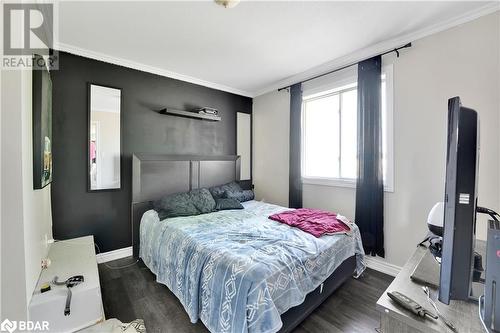 Bedroom with dark hardwood / wood-style flooring and crown molding - 8876 County Road 56, Utopia, ON 