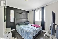 Bedroom with dark hardwood / wood-style flooring and crown molding - 