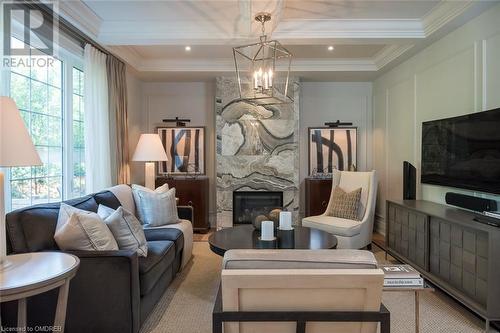 Stunning gas fireplace, walnut floors, Coffered ceiling, wainscotting. - 304 Mcgibbon Drive, Milton, ON - Indoor Photo Showing Living Room With Fireplace