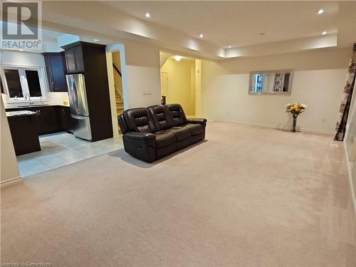 Carpeted living room featuring a raised ceiling and sink - 218 Gravel Ridge Trail, Kitchener, ON - Indoor