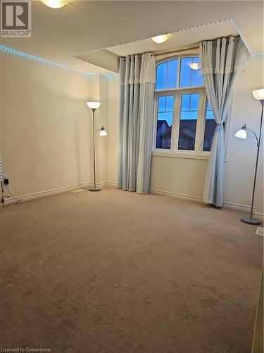 Empty room featuring carpet flooring - 218 Gravel Ridge Trail, Kitchener, ON - Indoor Photo Showing Other Room