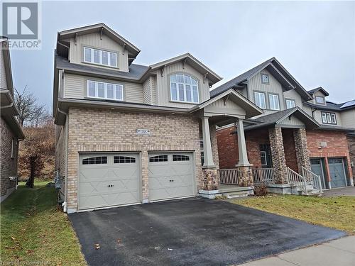 Craftsman inspired home featuring a porch, a garage, and a front lawn - 218 Gravel Ridge Trail, Kitchener, ON - Outdoor With Facade