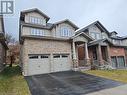 Craftsman inspired home featuring a porch, a garage, and a front lawn - 218 Gravel Ridge Trail, Kitchener, ON  - Outdoor With Facade 