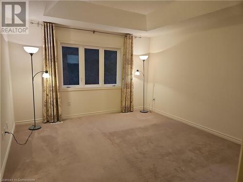 Carpeted spare room with a tray ceiling - 218 Gravel Ridge Trail, Kitchener, ON - Indoor Photo Showing Other Room