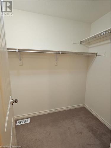 Walk in closet with dark colored carpet - 218 Gravel Ridge Trail, Kitchener, ON - Indoor With Storage