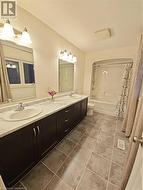 Full bathroom featuring shower / tub combo, vanity, and toilet - 