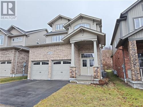 View of front facade with central AC, a garage, and a front lawn - 218 Gravel Ridge Trail, Kitchener, ON - Outdoor With Facade