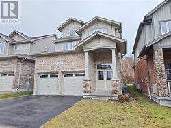 View of front facade with central AC, a garage, and a front lawn - 