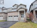 View of front facade with central AC, a garage, and a front lawn - 218 Gravel Ridge Trail, Kitchener, ON  - Outdoor With Facade 