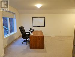 Office area with light colored carpet and vaulted ceiling - 