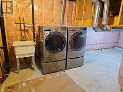 Washroom featuring washing machine and dryer and sink - 