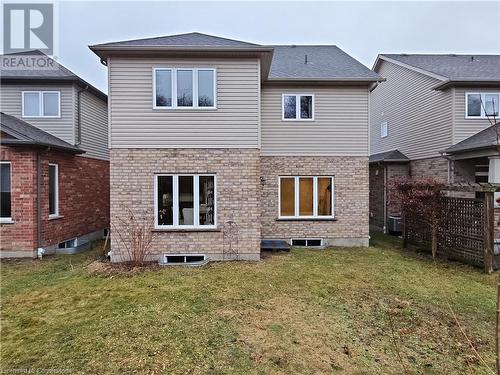 Rear view of property featuring a lawn and central air condition unit - 218 Gravel Ridge Trail, Kitchener, ON - Outdoor With Exterior