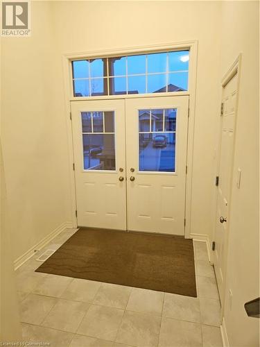 Doorway with light tile patterned floors - 218 Gravel Ridge Trail, Kitchener, ON - Indoor Photo Showing Other Room