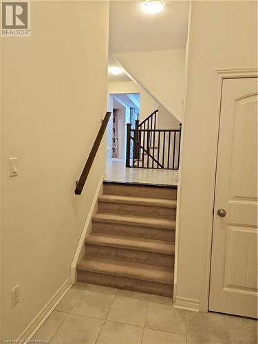 Staircase featuring tile patterned floors - 218 Gravel Ridge Trail, Kitchener, ON - Indoor Photo Showing Other Room