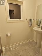 Bathroom featuring tile patterned flooring, toilet, and sink - 