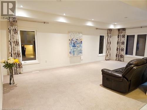 Living room with light carpet and a raised ceiling - 218 Gravel Ridge Trail, Kitchener, ON - Indoor Photo Showing Other Room