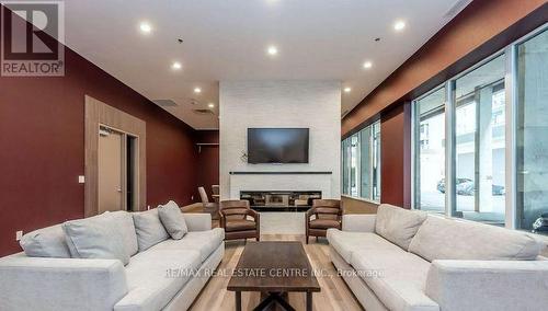 713 - 550 North Service Road, Grimsby, ON - Indoor Photo Showing Living Room With Fireplace