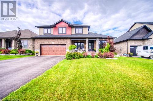 View of front facade featuring a garage and a front lawn - 66 Lock Street, Innerkip, ON - Outdoor With Facade