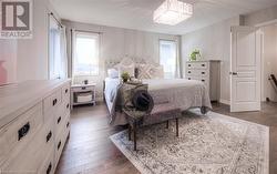 Bedroom with dark wood-type flooring and an inviting chandelier - 