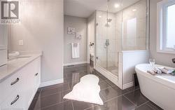 Full bathroom with tile patterned flooring, vanity, separate shower and tub, and toilet - 