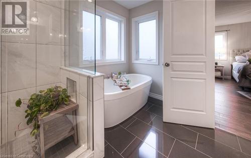 Bathroom featuring a bath and tile patterned floors - 66 Lock Street, Innerkip, ON - Indoor Photo Showing Bathroom