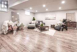 Living room with a healthy amount of sunlight and light wood-type flooring - 